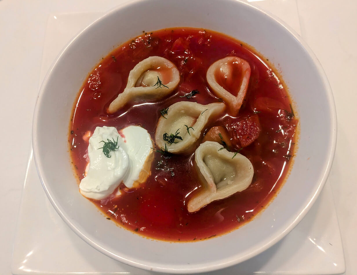 A bowl of borscht with vushka, little ear Ukrainian dumplings.